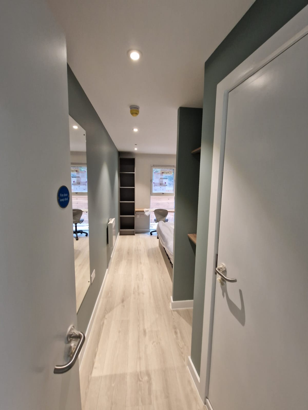 Hallway painting in an apartment by Painters and decorators Edinburgh in white and sage green