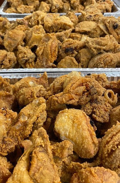 Fried chicken pieces arranged in metal trays