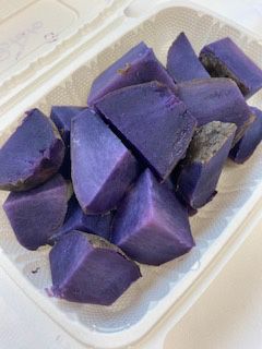 Purple sweet potato chunks in a white takeout container