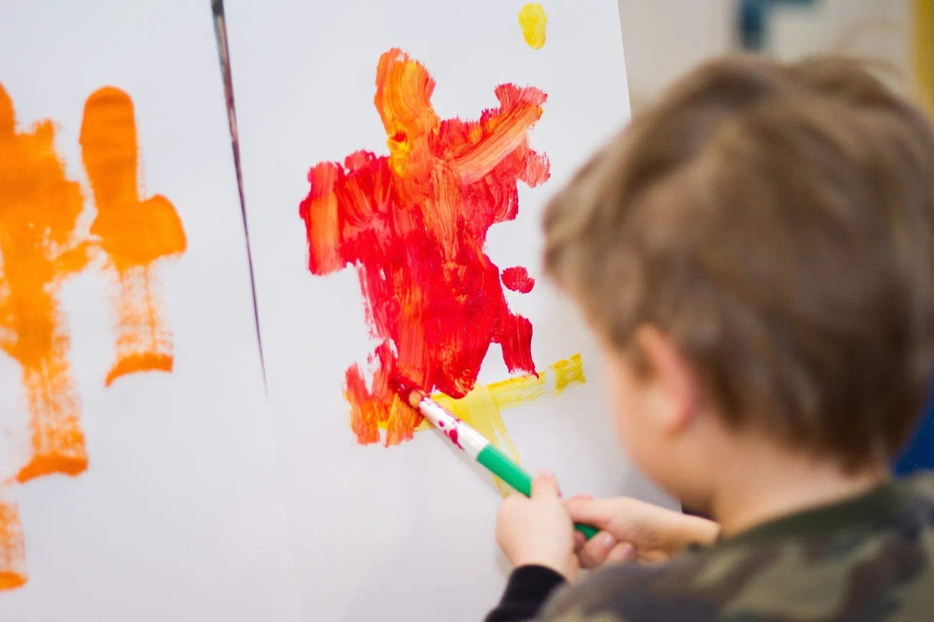 Child painting on a canvas