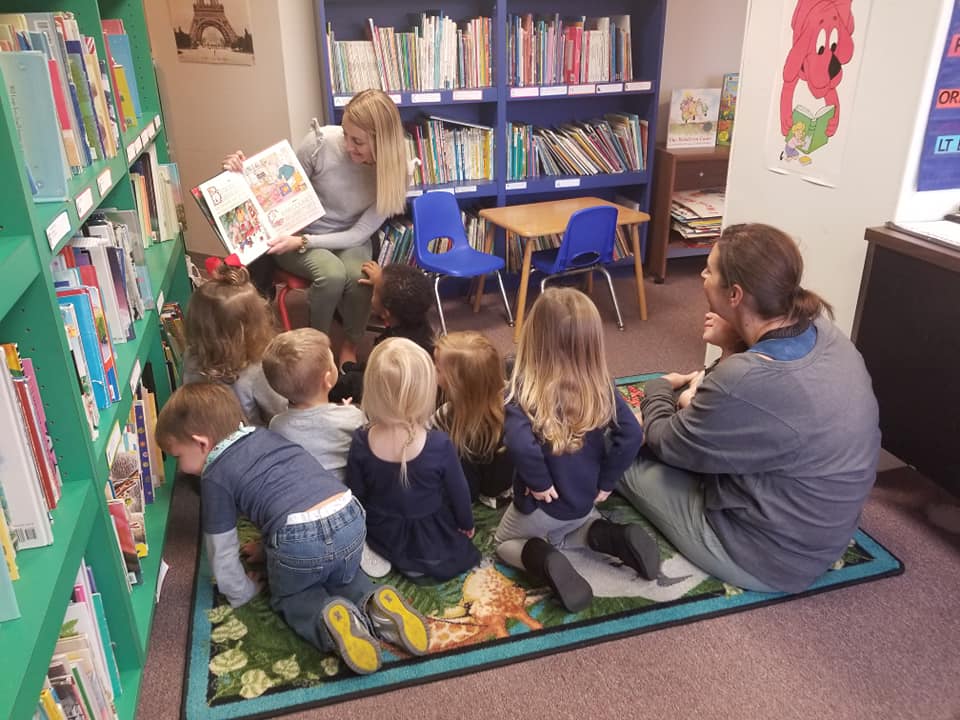 Teacher reading to a group of children