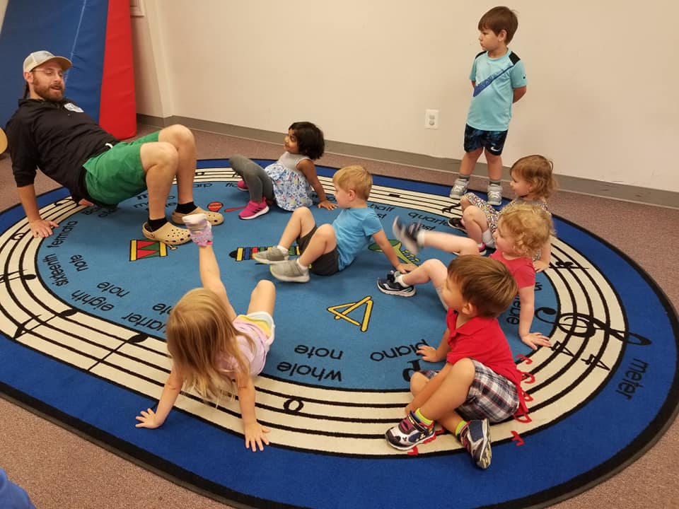 children exercising on a mat