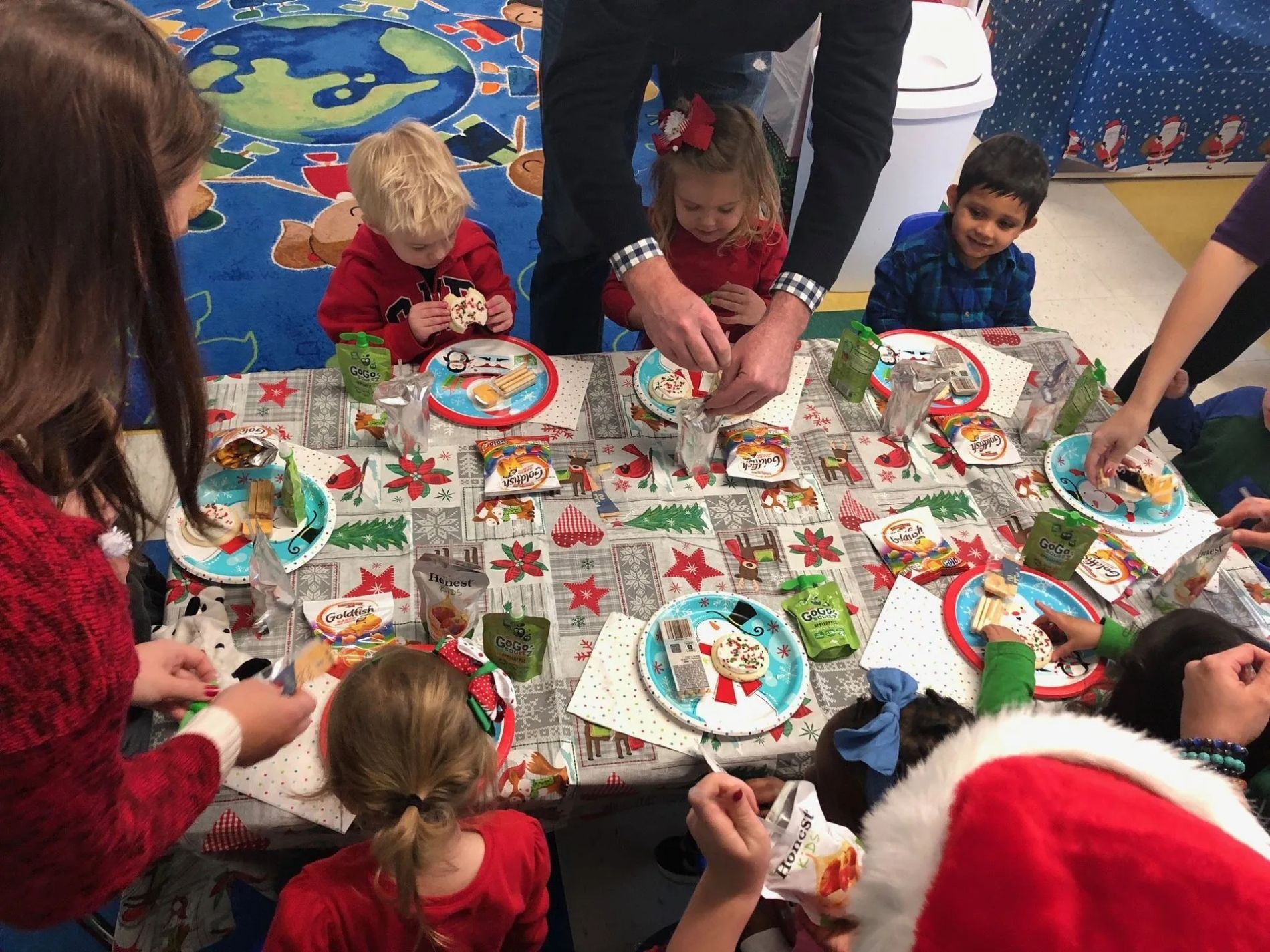 children eating cookies at a holiday party