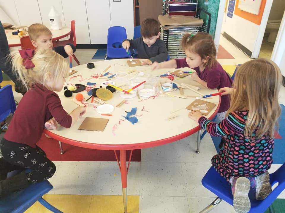 children working on art in a group