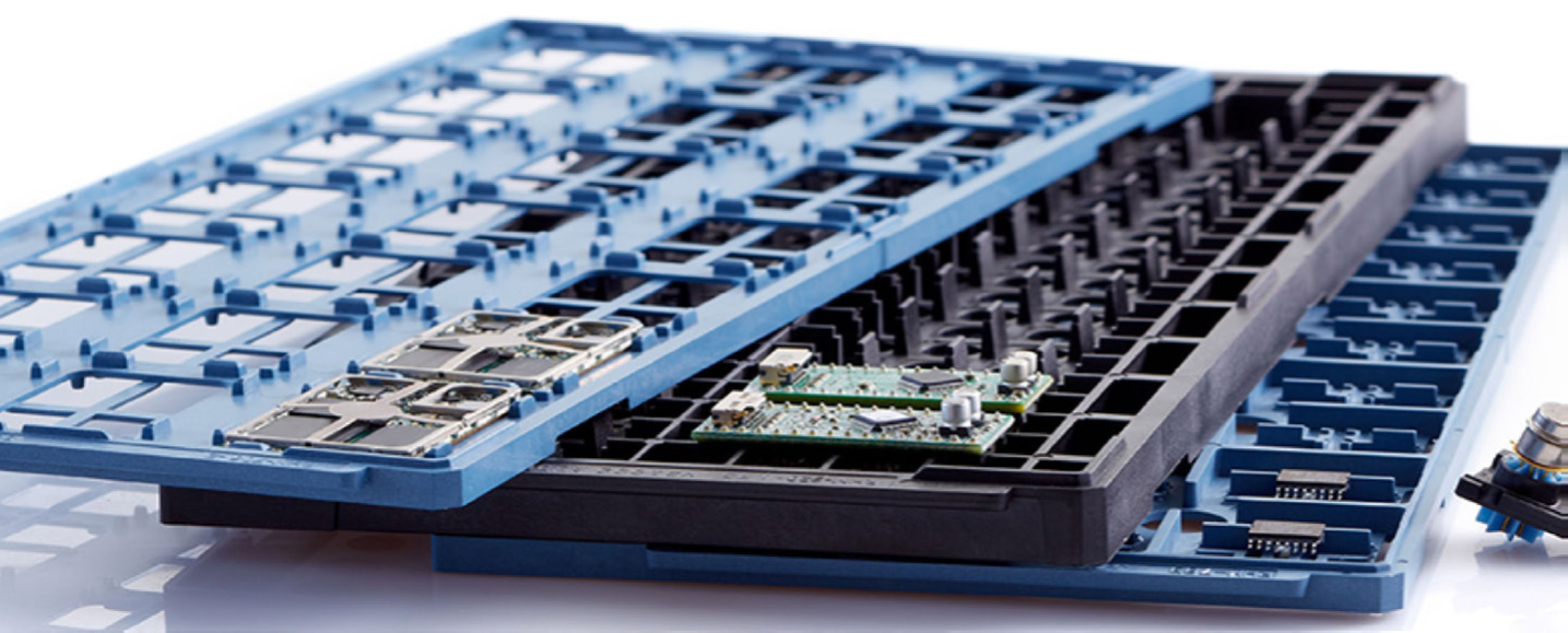 Christmas tree-shaped plastic thermoformed trays filled with festive cookies: stars, Santas, reindeer, and elves. Red and colorful.