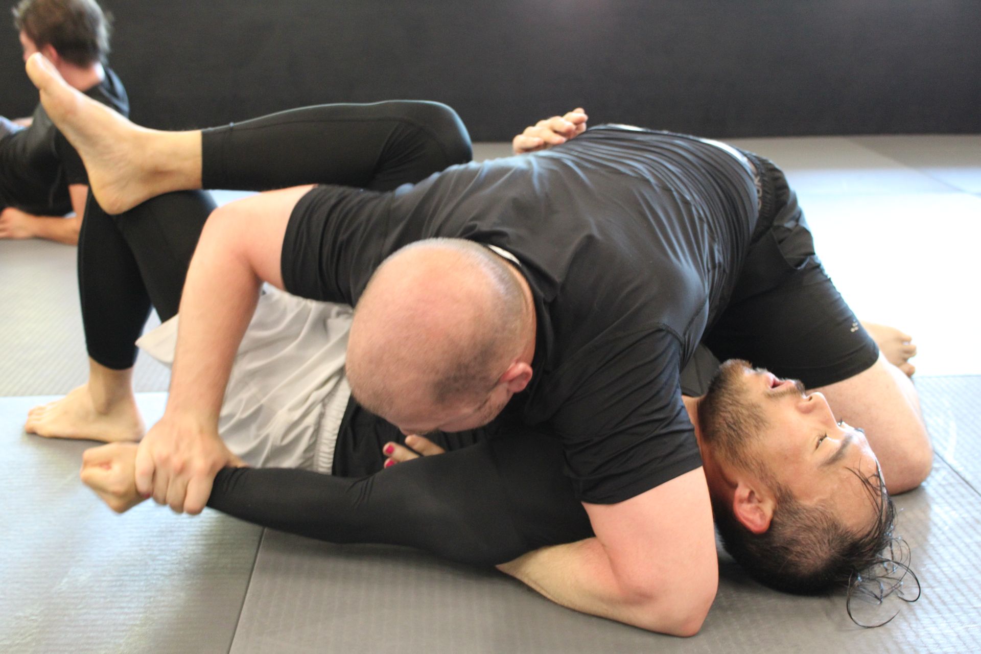 Training partners drill grappling technique at Lógica Brazilian Jiu-Jitsu in Chattanooga, TN.