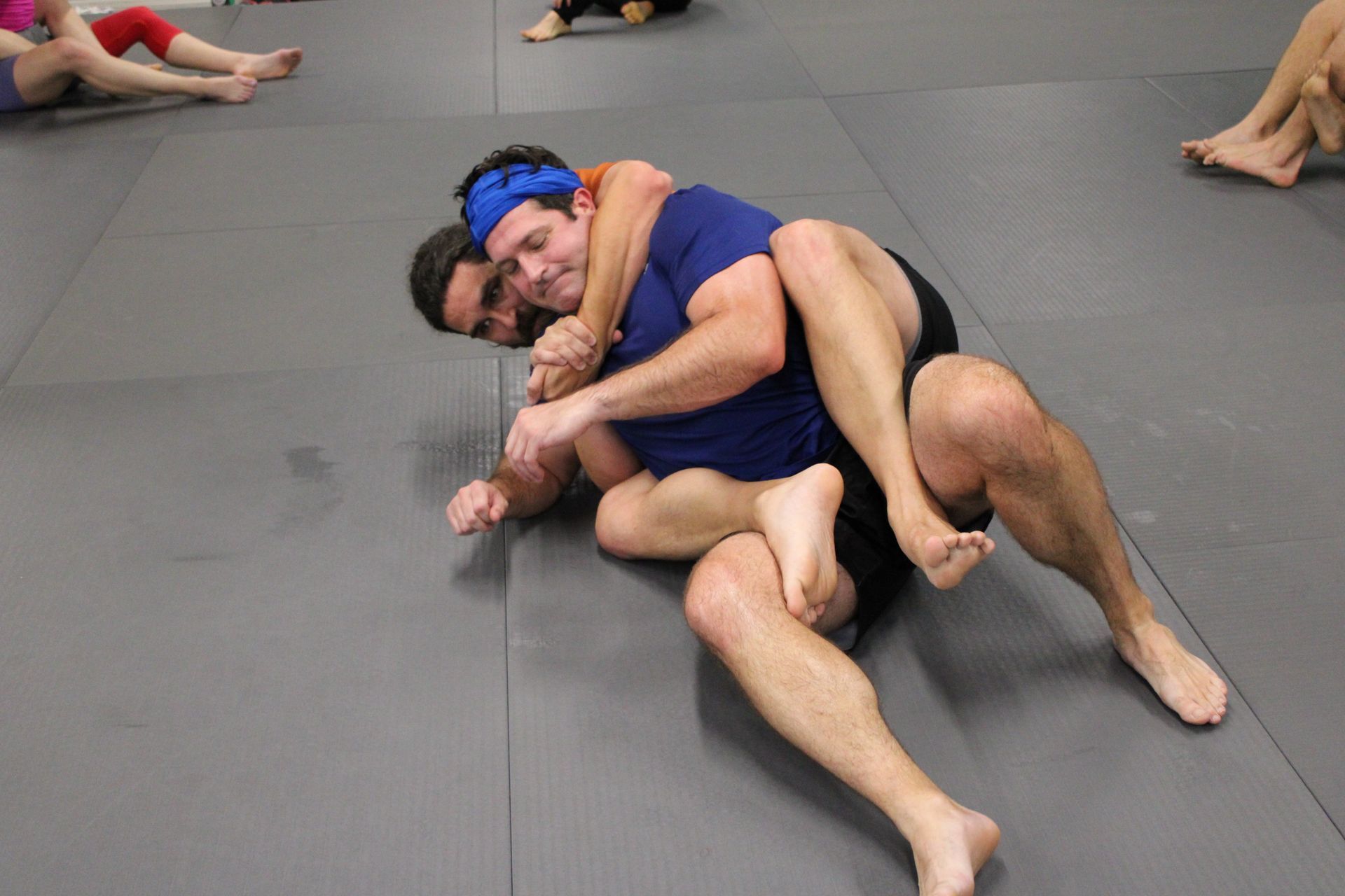 Adults practicing grappling drills at Lógica Brazilian Jiu-Jitsu in Chattanooga, TN.