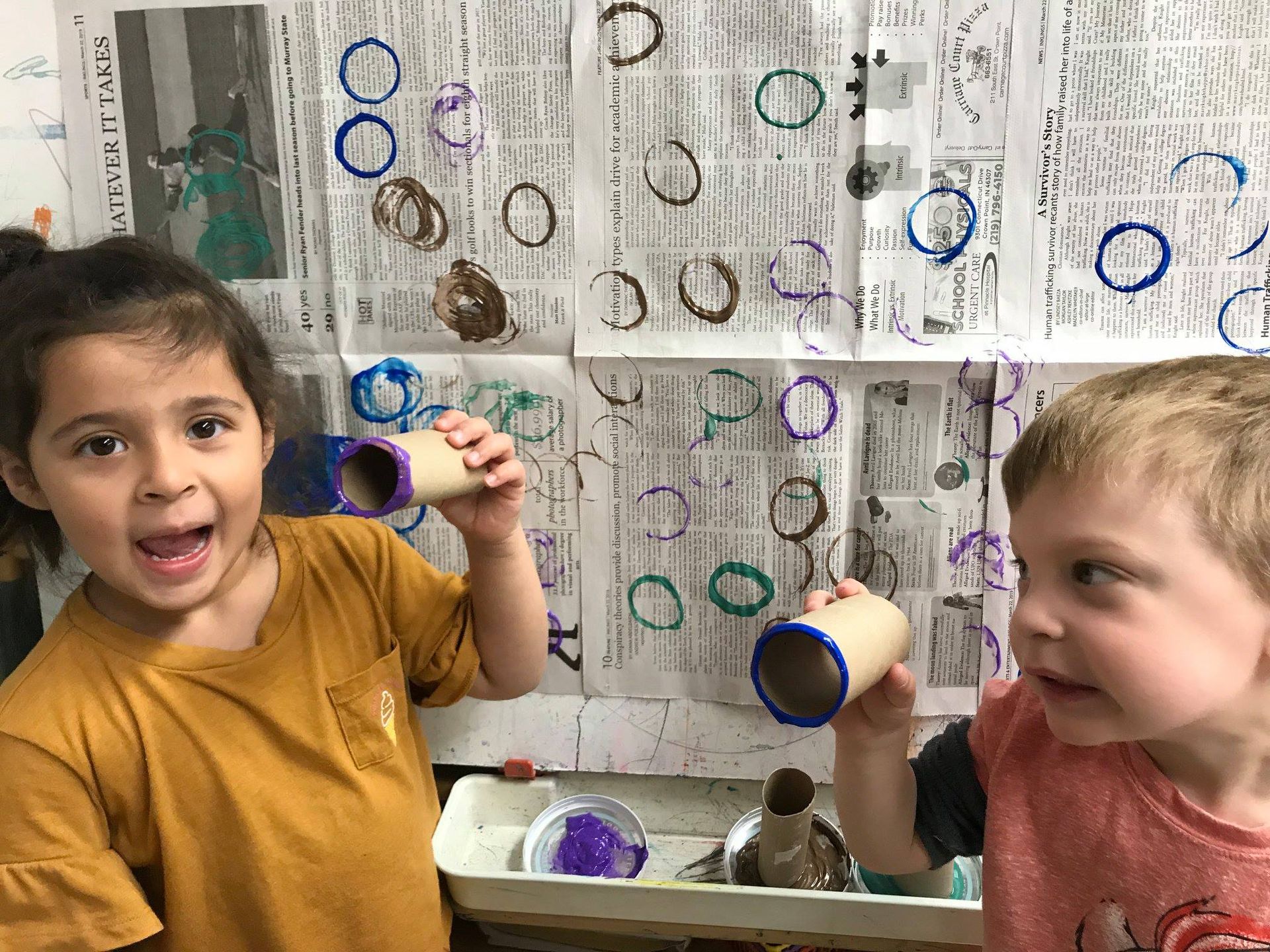 A boy and a girl are hugging each other in a room.