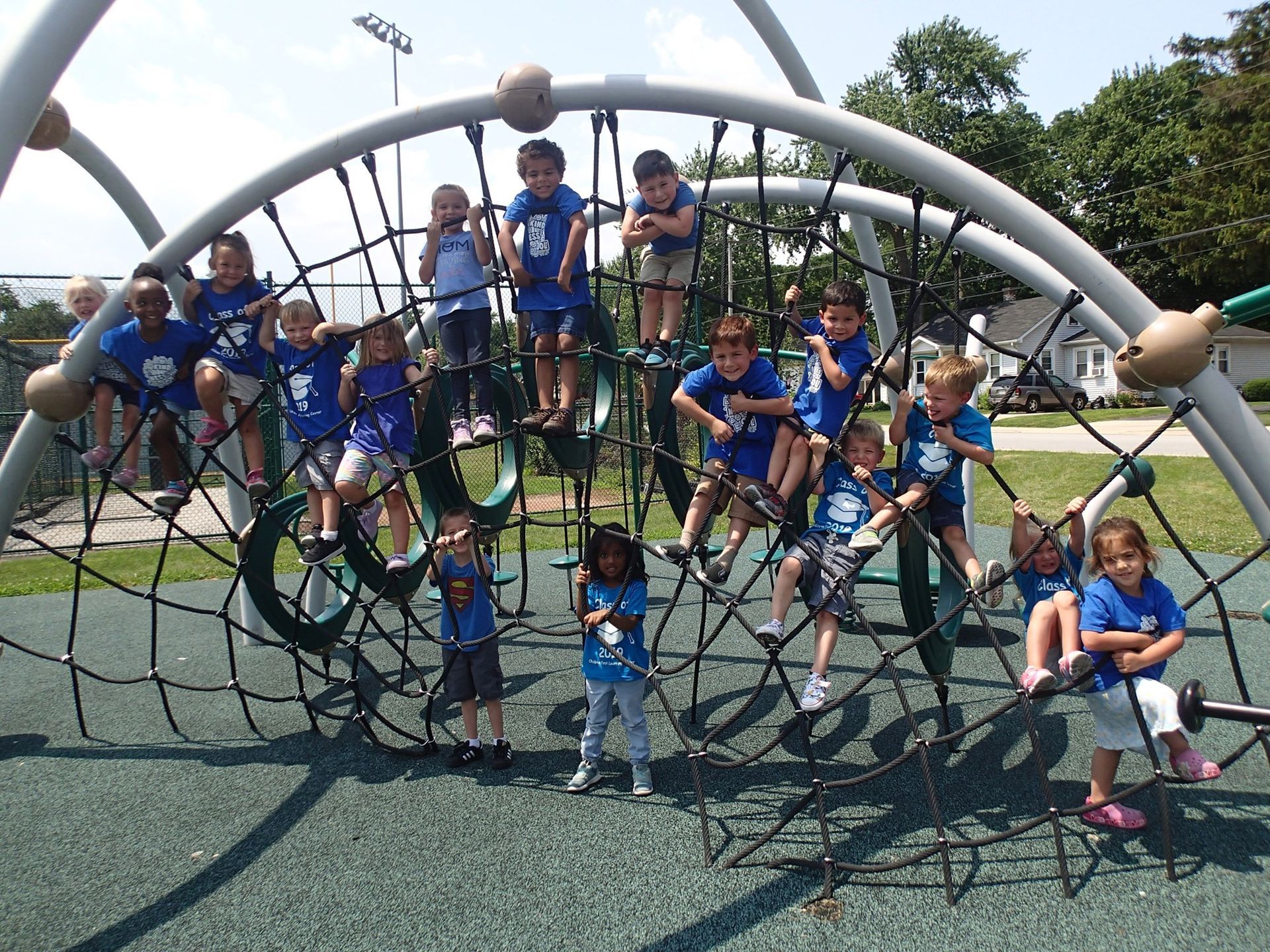 A group of children are posing for a picture on a playground