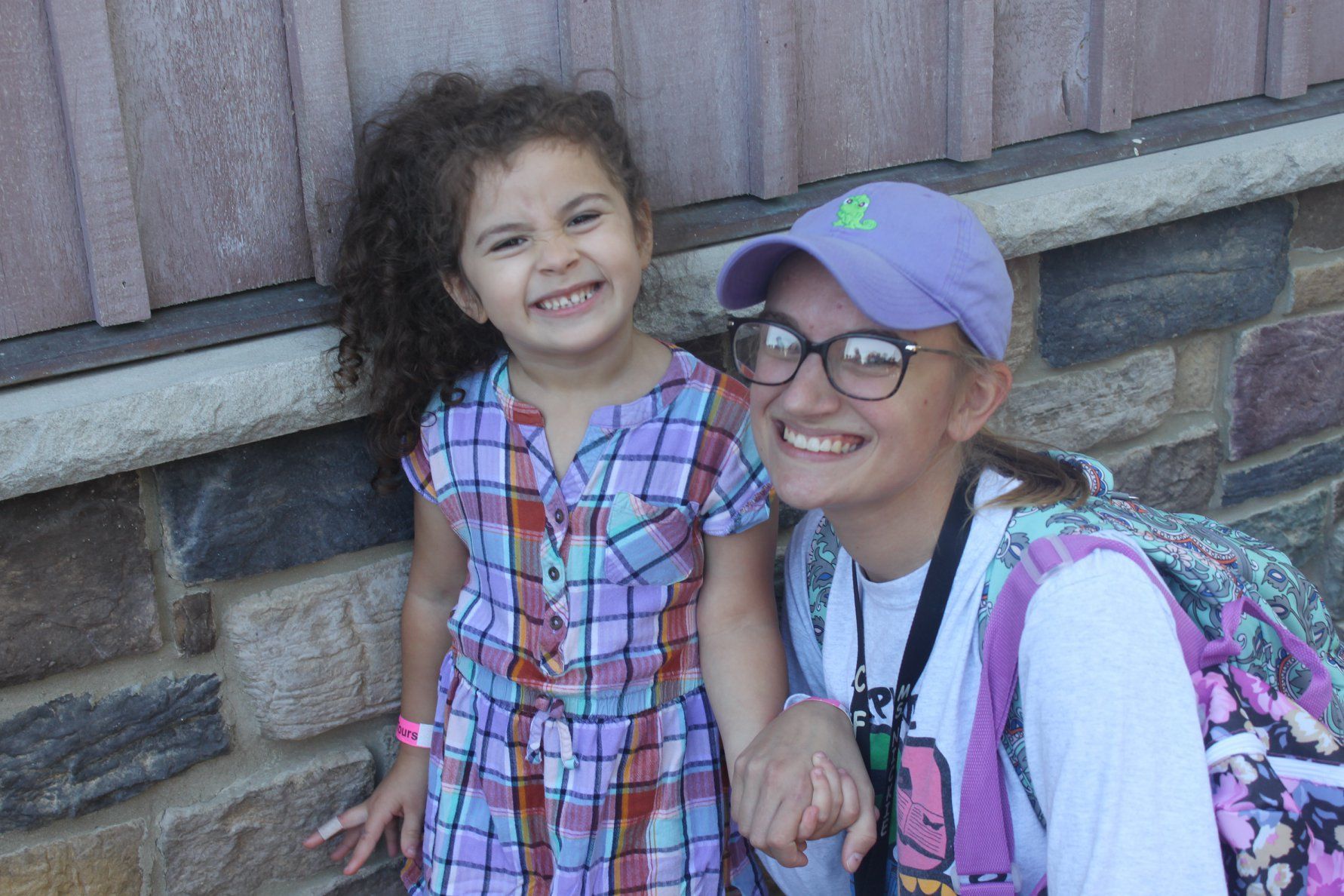 A little boy is laying on the floor playing with a toy castle