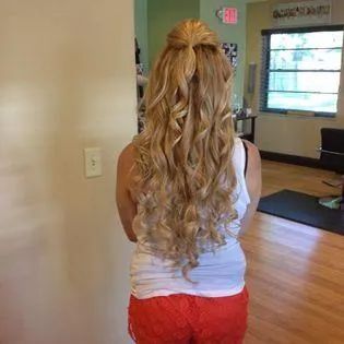 A woman with long blonde hair is standing in a room