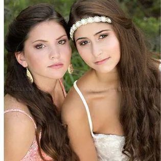 Two young women are wearing a flower headband
