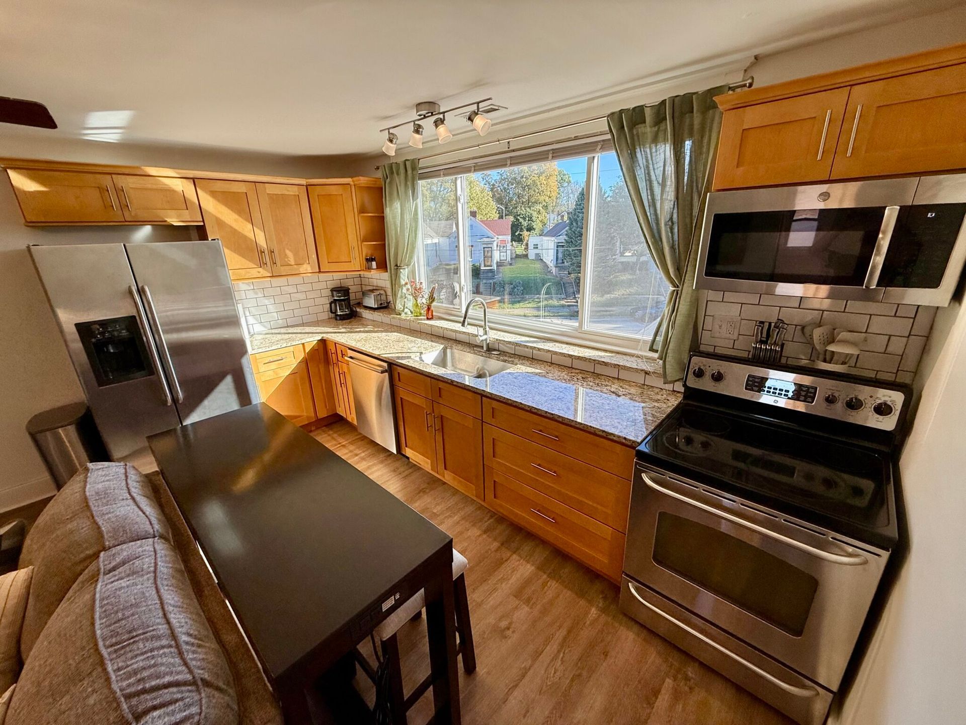 A kitchen with stainless steel appliances and wooden cabinets