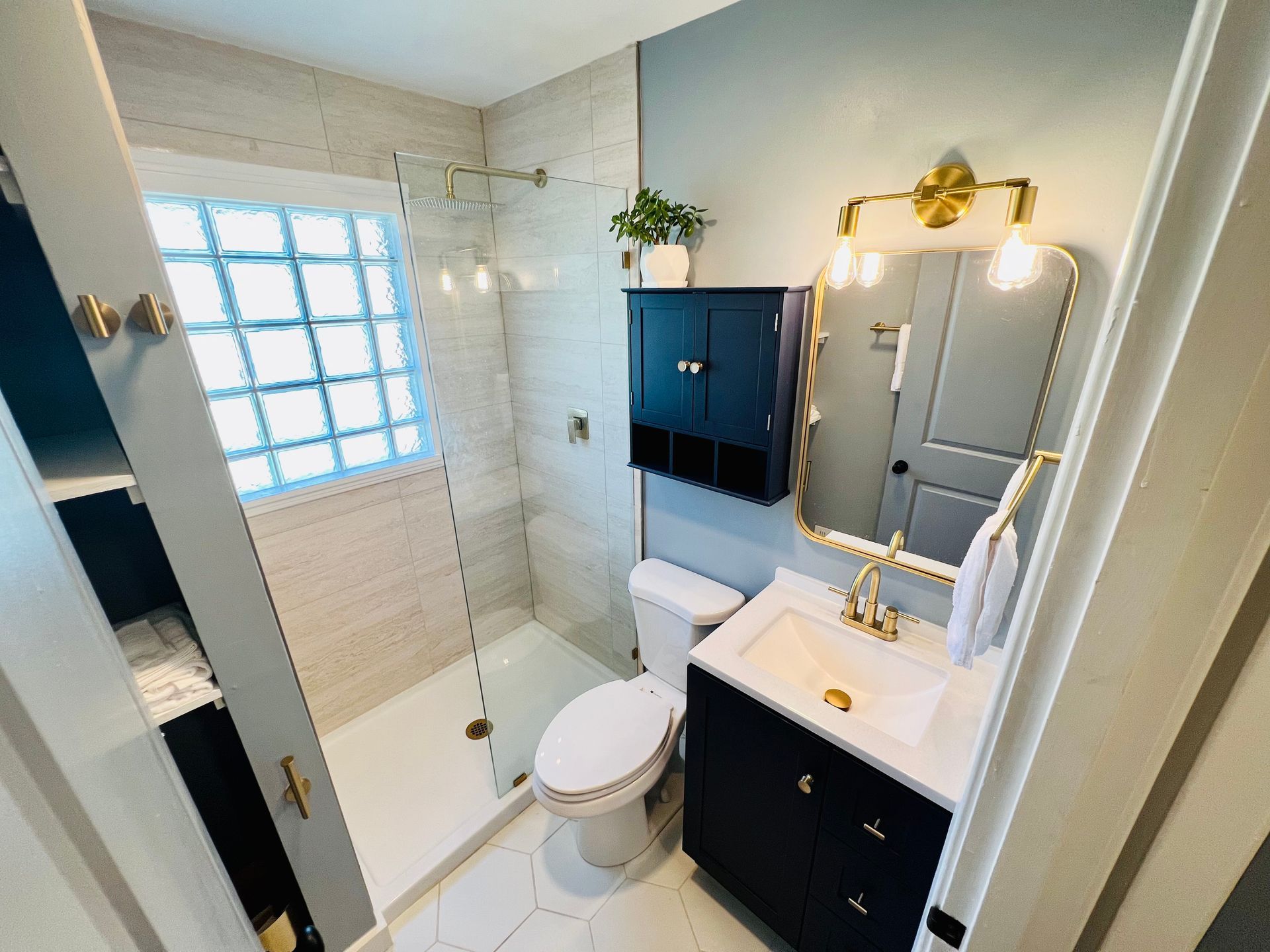 A bathroom with a toilet , sink , and shower.