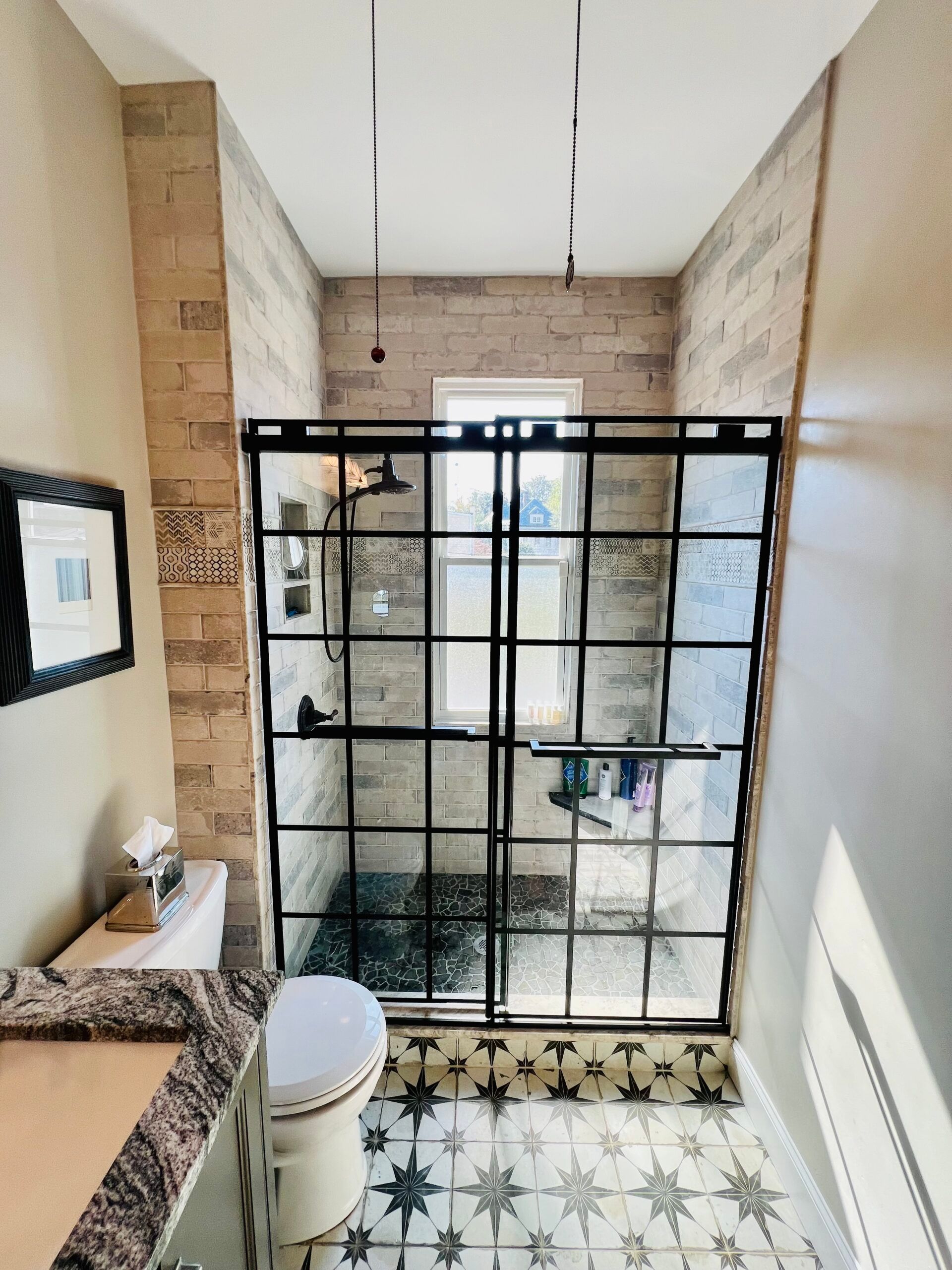 A bathroom with a toilet and a walk in shower