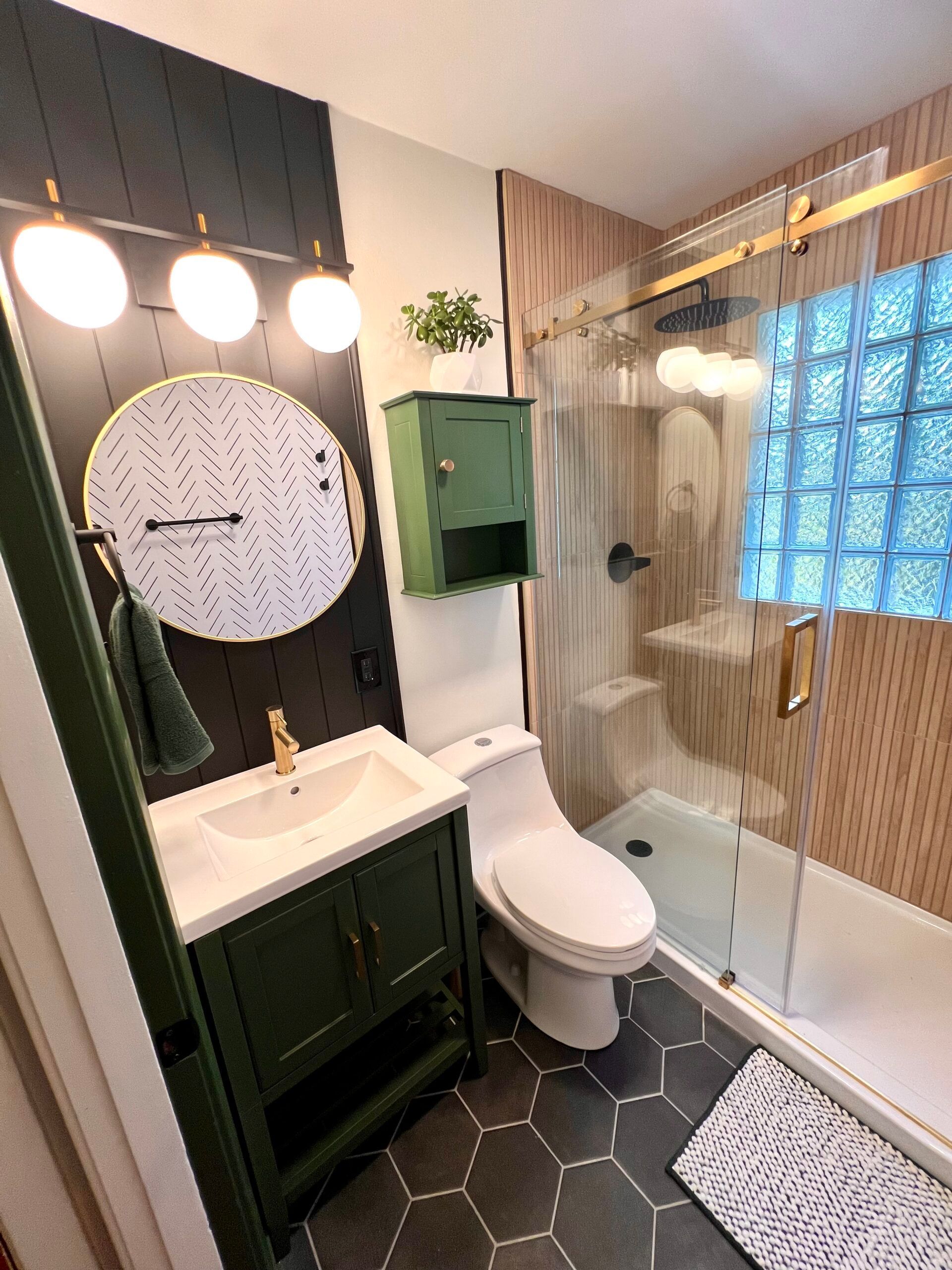 A bathroom with a toilet , sink , and shower.