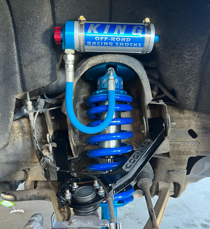 A king off road racing shock is attached to the front of a vehicle