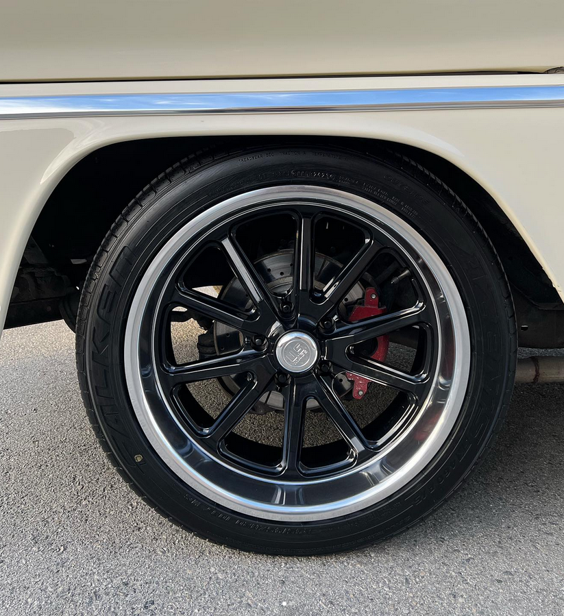 A close up of a car wheel with a tire on it.