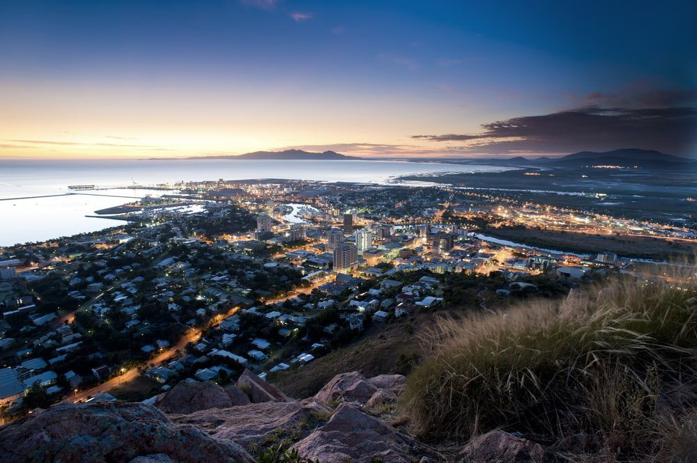 An Aerial View Of A City From A Mountain At Sunset — Tonics Automotive in Mt Low, QLD