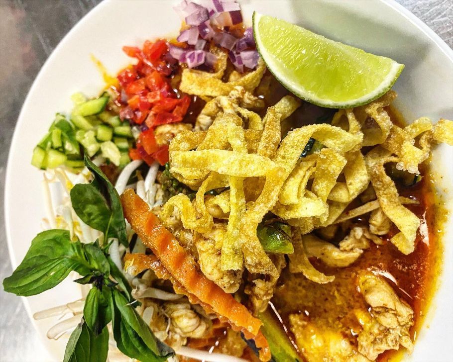 A Close Up of a Plate of Food With Noodles and Vegetables on a Table — Sway Thai Fusion & Bar In Tweed Heads South, NSW