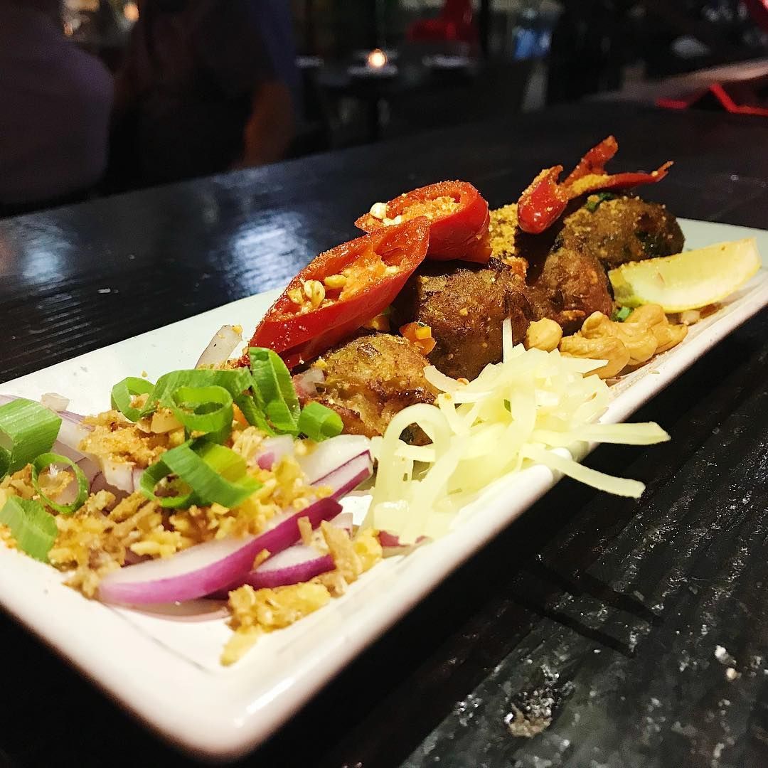 A Plate of Food With Peppers Onions and Cheese on a Table — Sway Thai Fusion & Bar In Tweed Heads South, NSW
