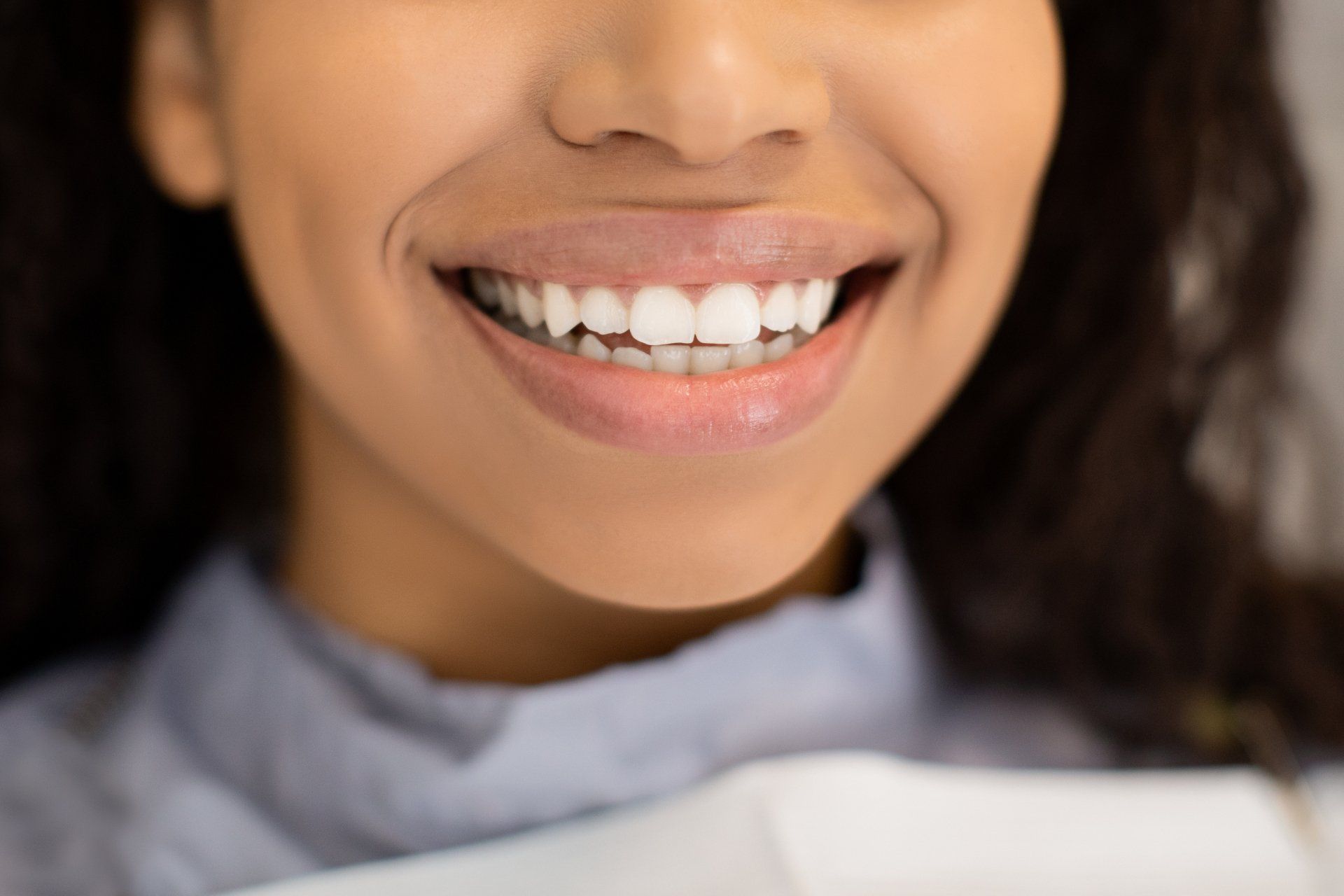 Close up image of woman smiling after teeth whitening procedure