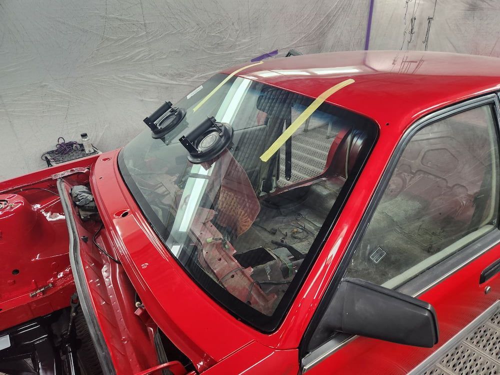 A Red Car With a Yellow Line on the Windshield — MJR Auto Glass In Southern Highlands, NSW
