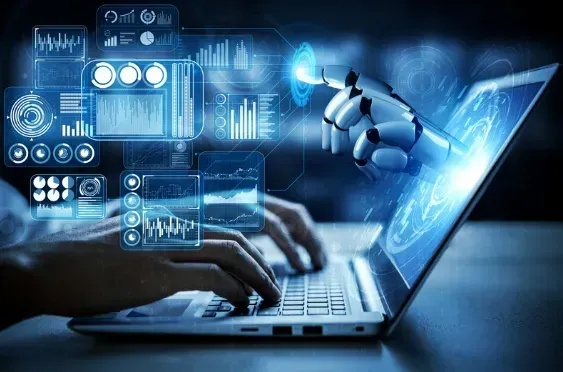 A person is typing on a laptop computer with a robotic hand coming out of the screen.