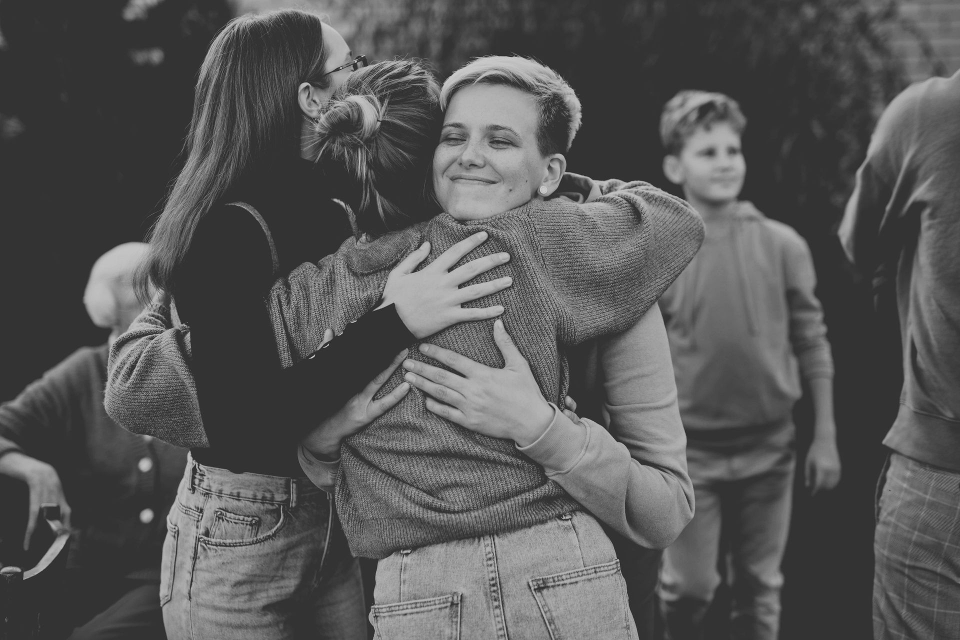 A person is walking down the street with a green umbrella.