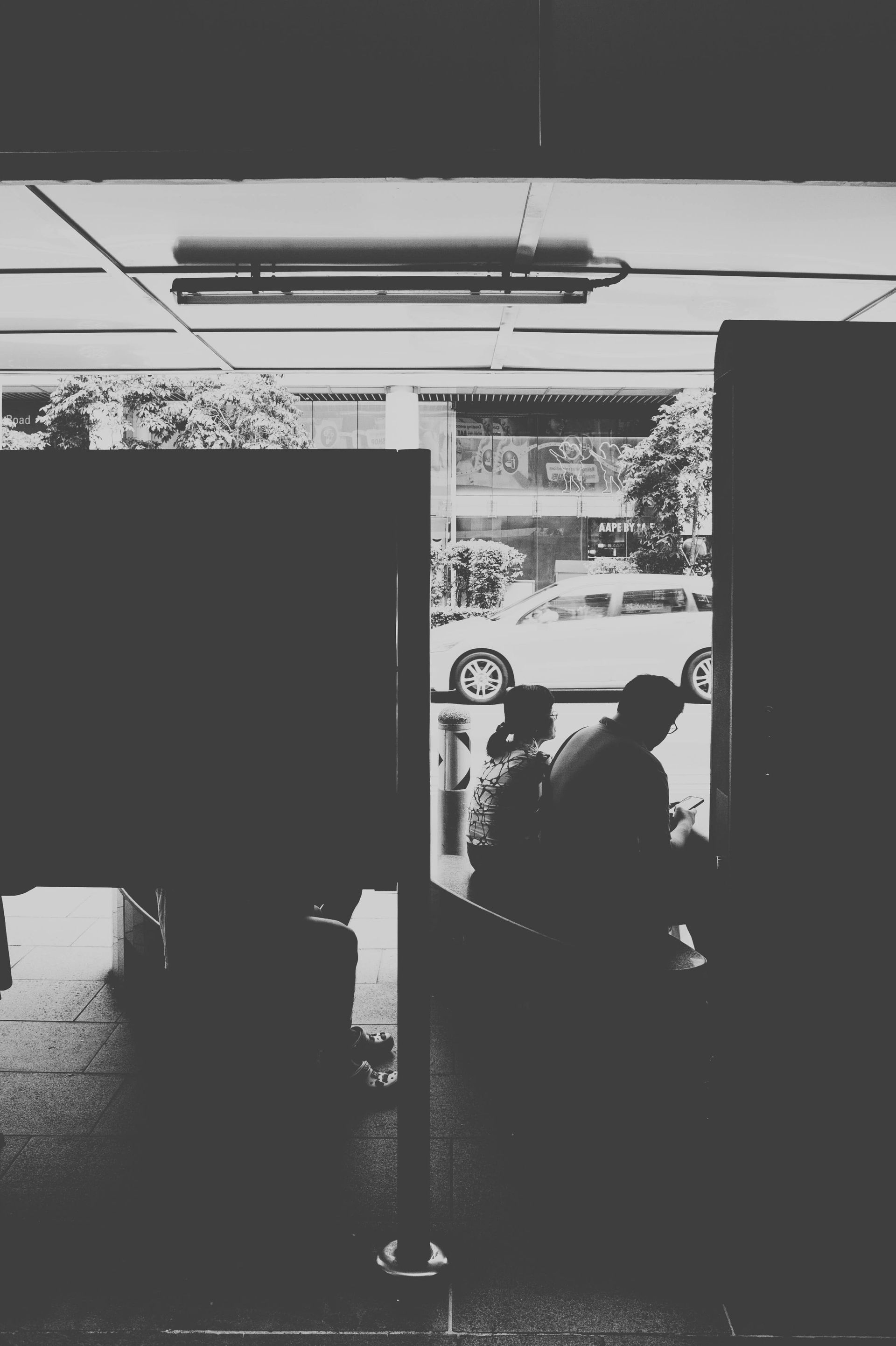 A man and a woman are hugging each other while sitting on a bench.