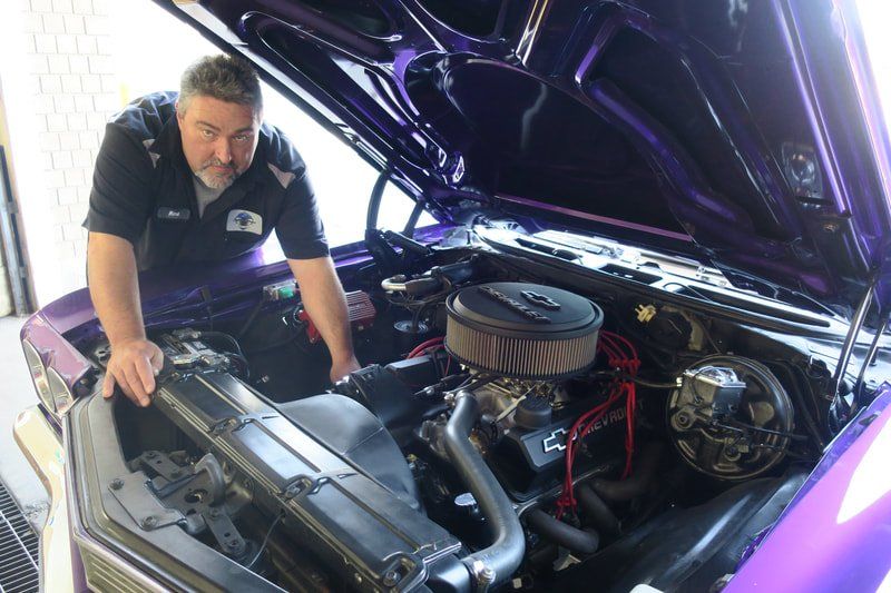 mechanic working on classic car cottonwood auto care