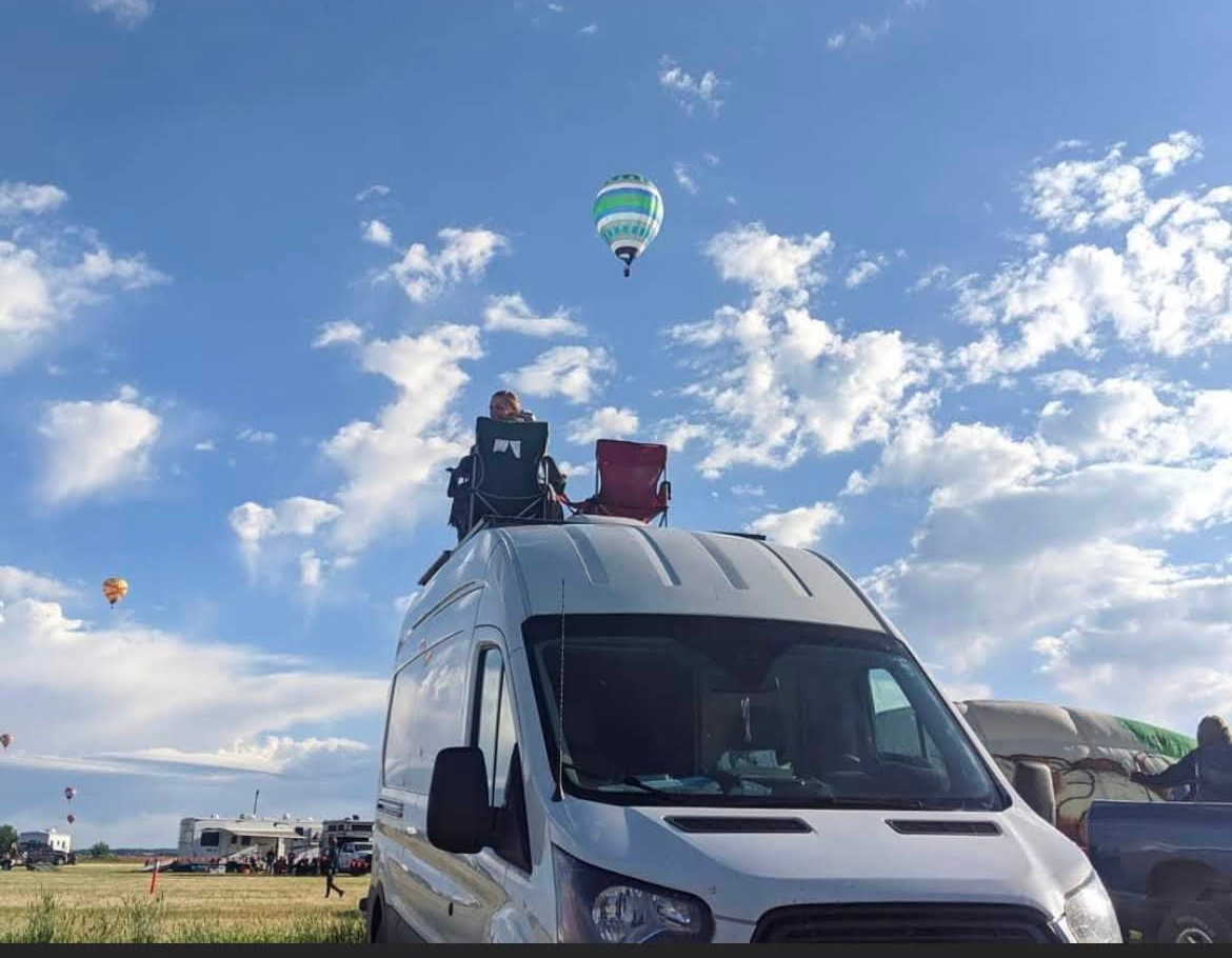 Aurora Matthews Watching hot air balloons from on top of her and Justin Craddock's campervan