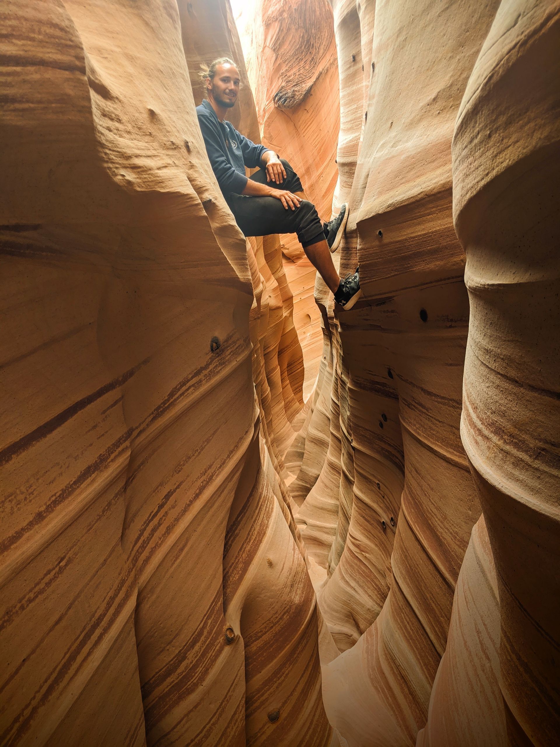 Justin Craddock hanging out between the cliffs in some of the slot canyons in Utah