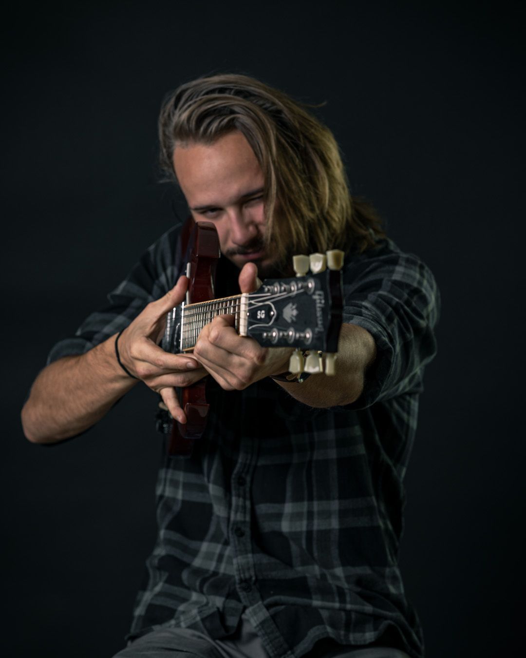 Winnipeg guitar player, Justin Craddock, aiming the guitar at the camera