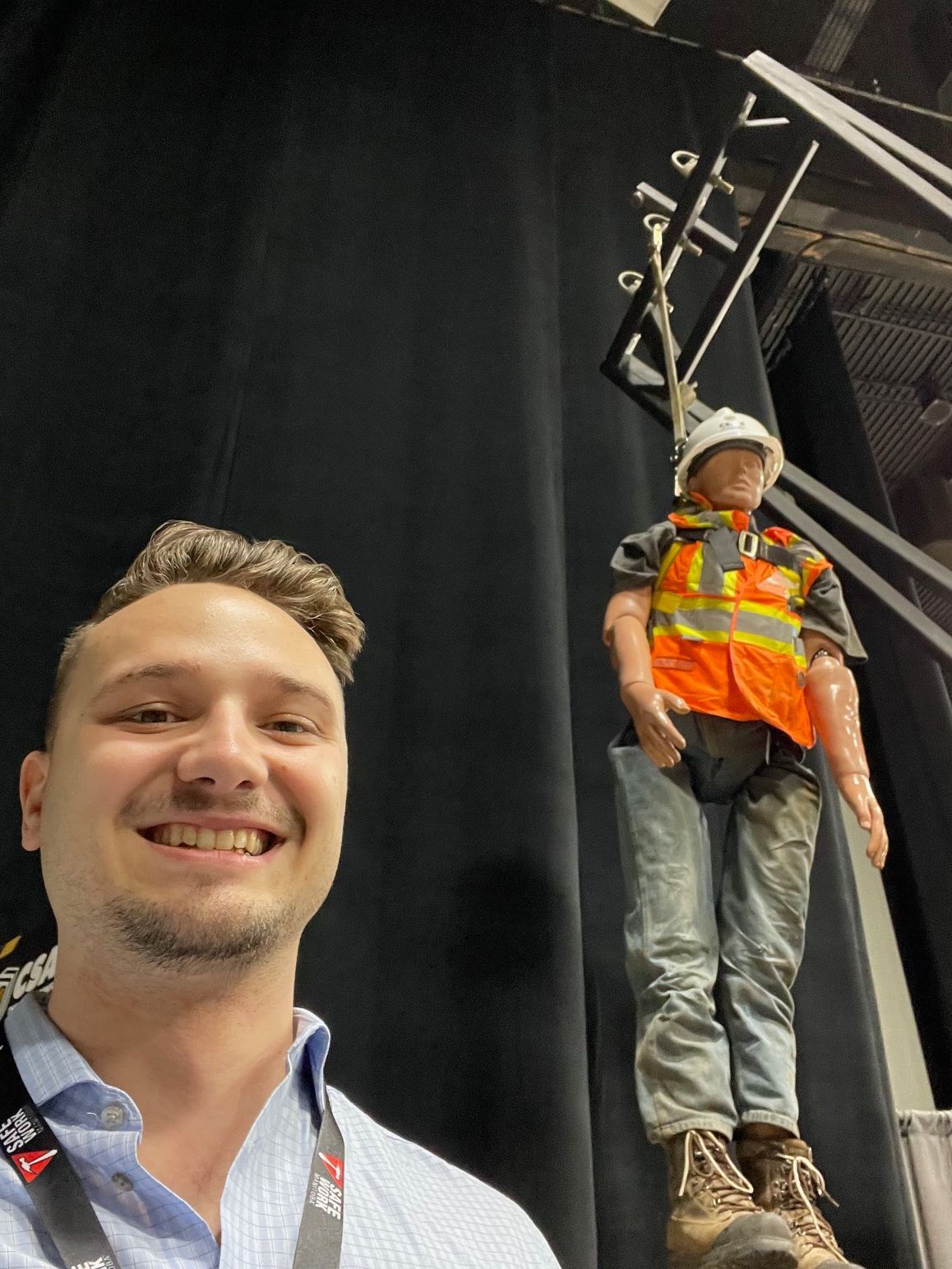 CSAM Safety Conference 2023, Justin Craddock posing beside a fall dummy