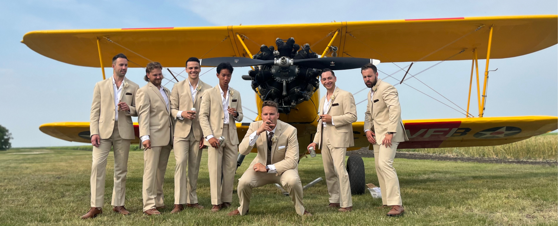 Justin Craddock looking cool with his groomsmen at his farm wedding in front of an airplane in Fannystelle Manitoba