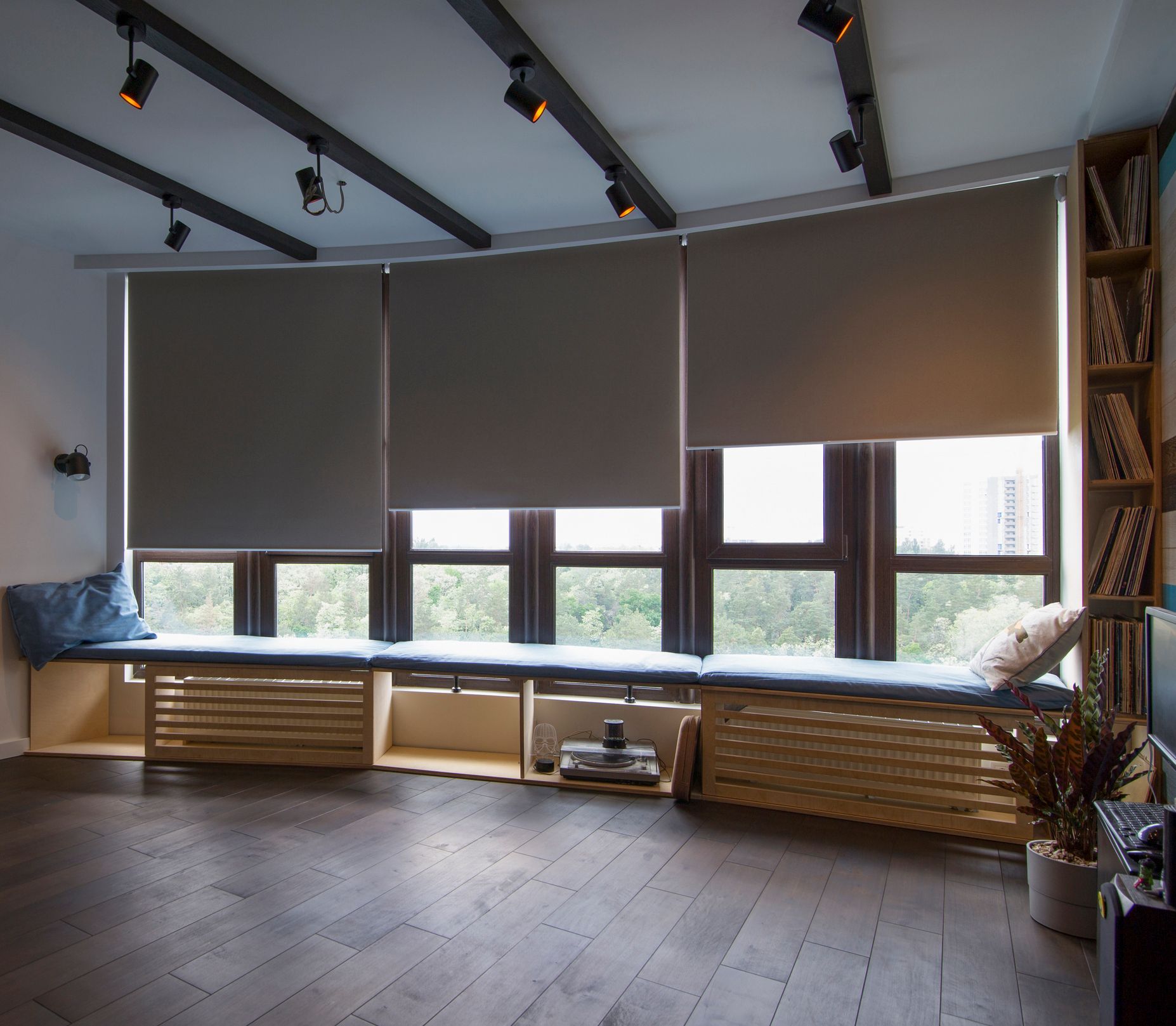 Modern interior featuring motorized blinds on windows for stylish light control.