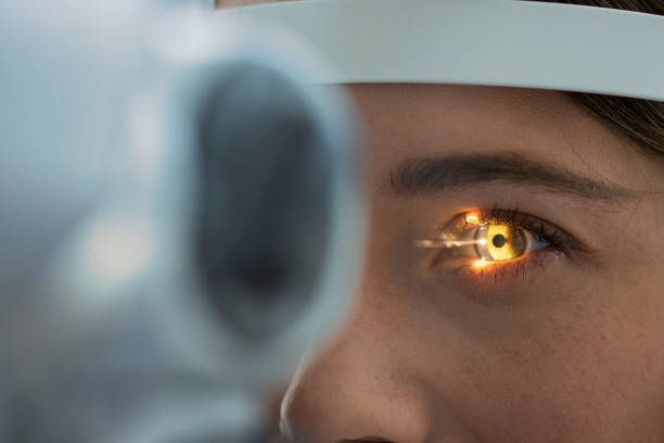 A woman is getting her eyes examined by an ophthalmologist.