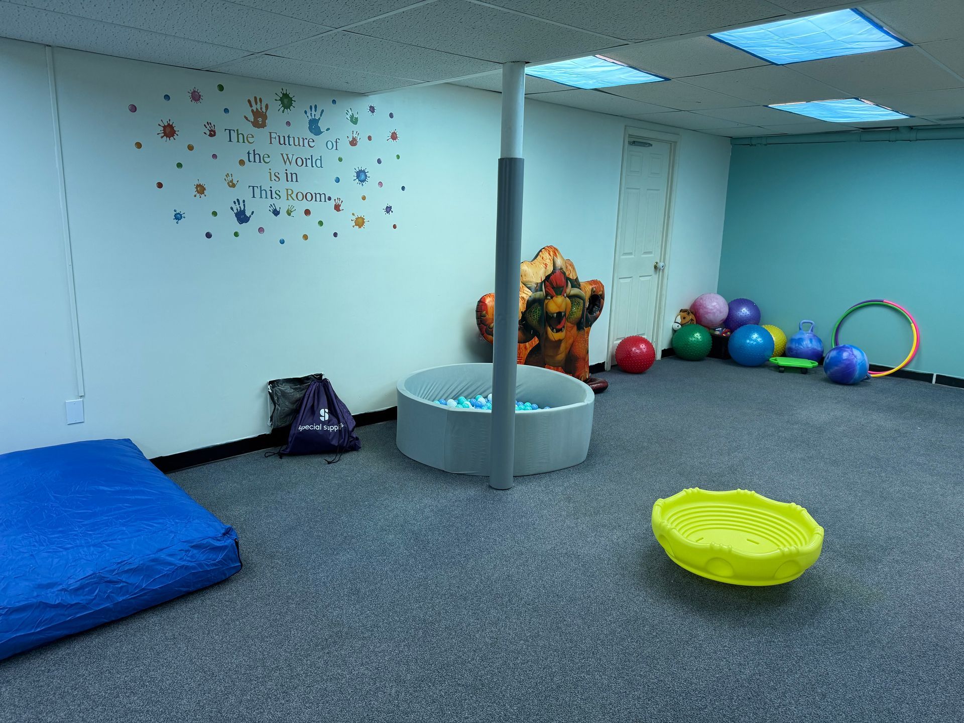 A Group of Children Are Sitting at a Table in a Classroom Playing With Toy