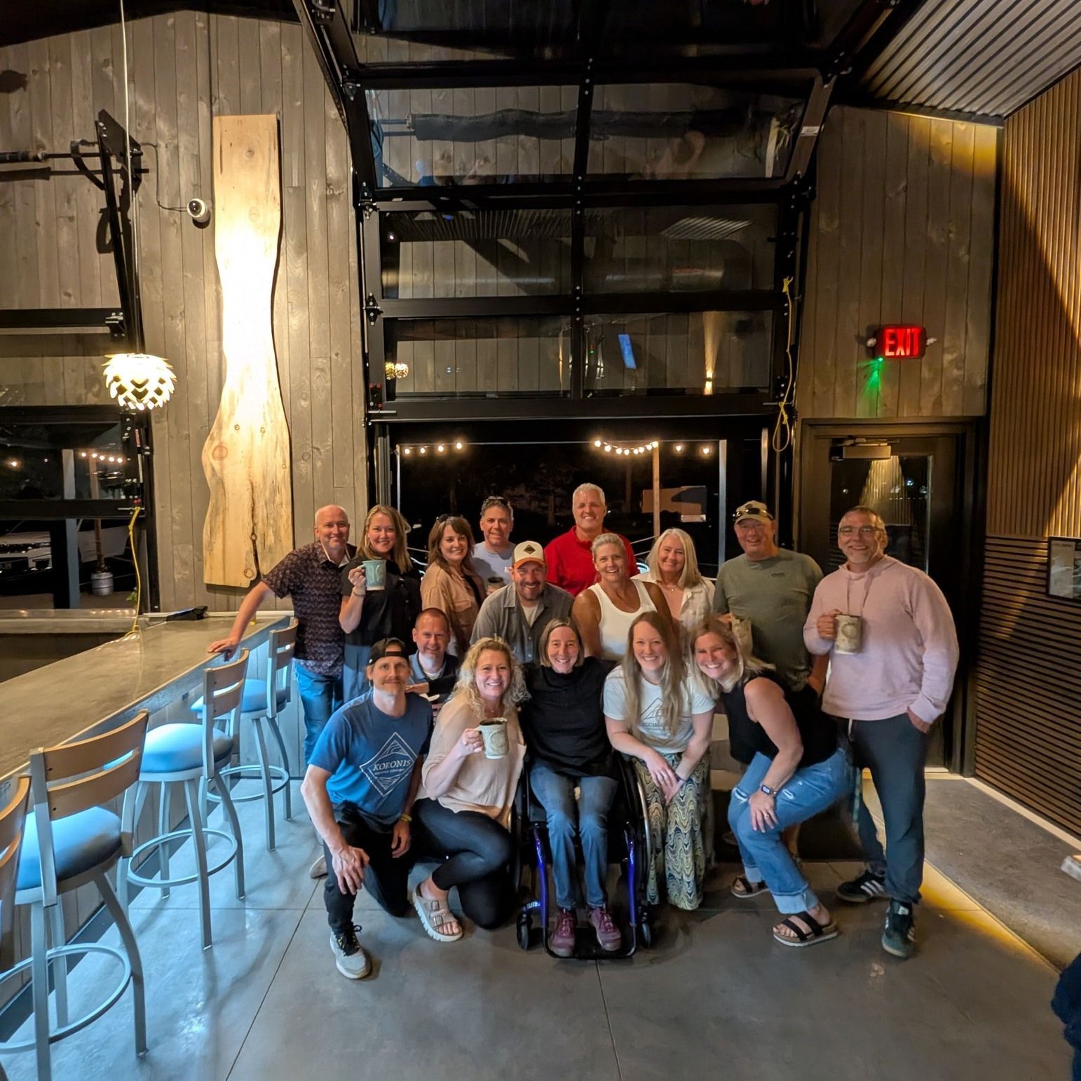 A group of people are standing in front of a coming soon sign.