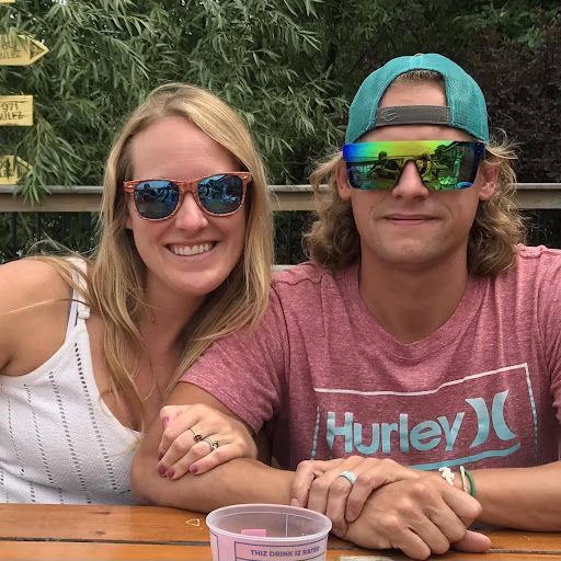 A man and a woman wearing sunglasses and a hurley shirt