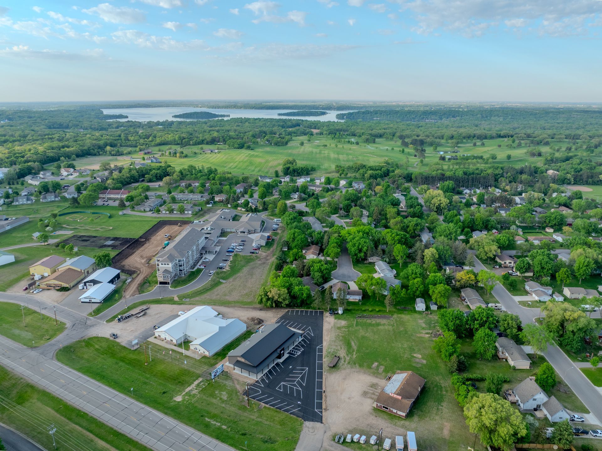 Three glasses of beer are sitting on a wooden table.