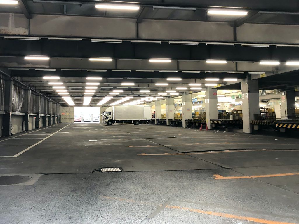 An empty parking garage with trucks parked in it.