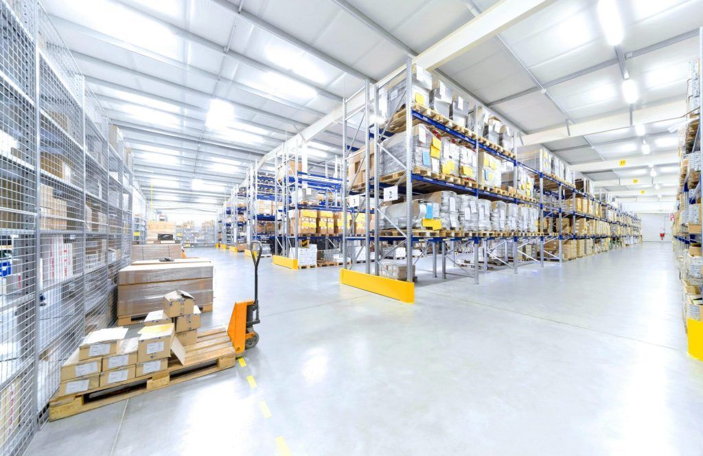 A large warehouse filled with lots of shelves and boxes.