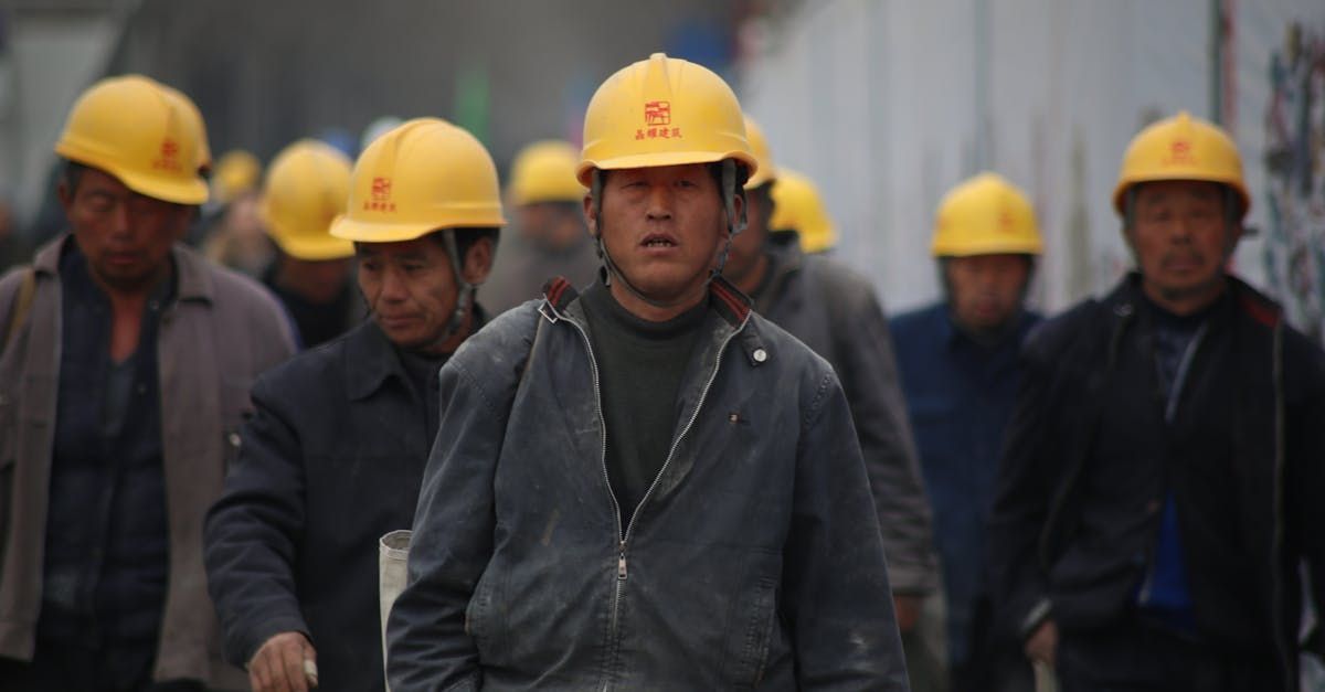 A group of construction workers wearing yellow hard hats