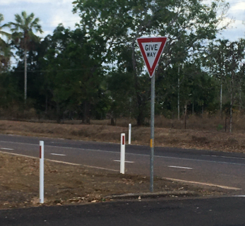 A give way sign on the side of a road