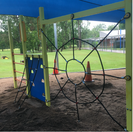 A playground with a spider web in the middle of it