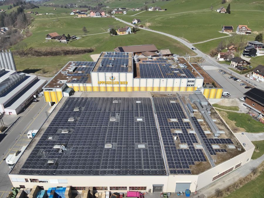 Drohnenaufnahme eines grossen Industriegebäude-Flachdachs mit Solaranlage