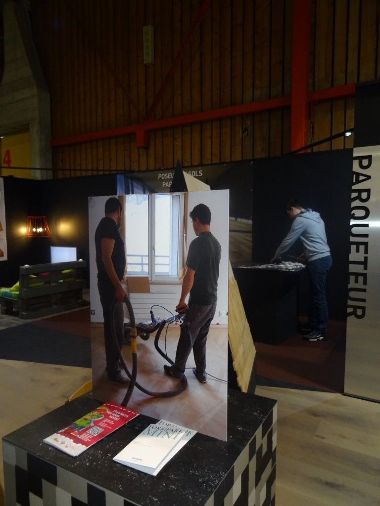 Deux hommes se tiennent devant un panneau indiquant parqueteur