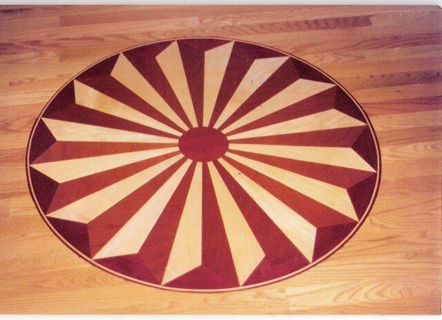 A wooden floor with a circular design on it